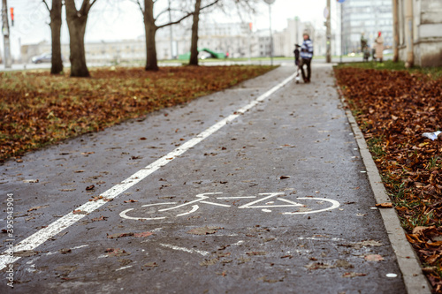 Wallpaper Mural A bike path in city public park on autumn day. A boy standing in the distance Torontodigital.ca