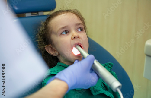 Child at the dentist's appointment. Doctor's appointment. Little girl treats teeth