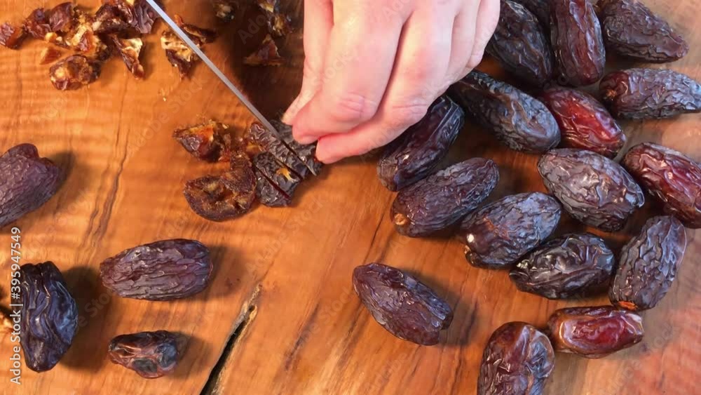 chopping dried Medjool dates on cutting board flat lay