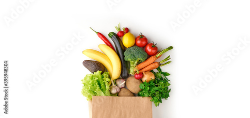 Fototapeta Naklejka Na Ścianę i Meble -  Paper grocery bag full of healthy fruits and vegetables top view isolated on white background