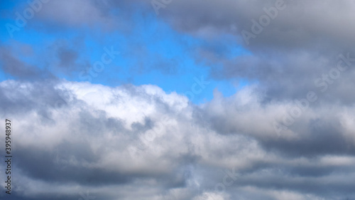 Dark clouds against a blue sky