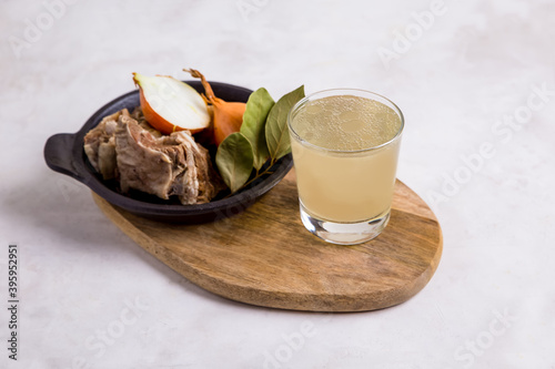   beef bone broth on a light background. Healthy, low-calorie foods are rich in vitamins, collagen, and anti-inflammatory amino acids.