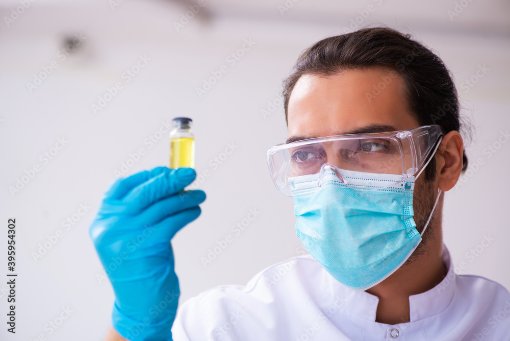 Young male chemist working in the lab