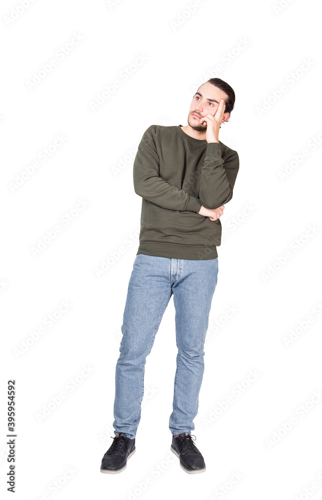 Fotografie Full length portrait pensive young man, keeps fingers to temple, thoughtful gesture, isolated on white background with copy space