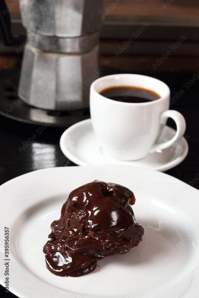 Choux with chocolate ganache and coffee cup Choux with chocolate ganache and coffee cup