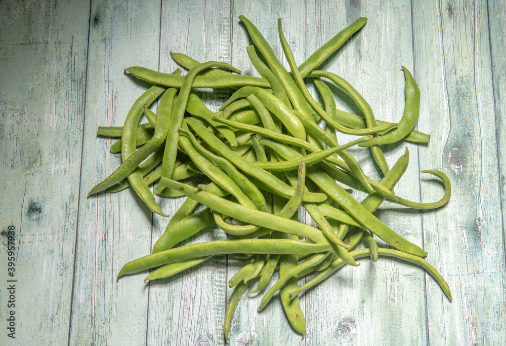 Homegrown green beans on a green wooden background Homegrown green beans on a green wooden background
