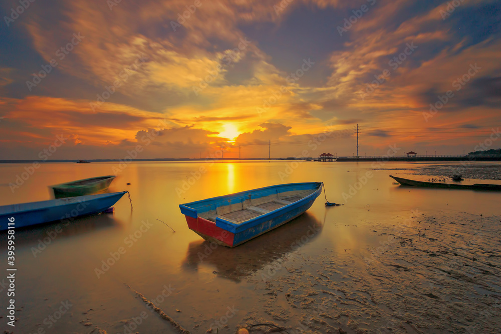 A scenic beauty of traditional fishing boat with sunset at Teluk Sengat,Johore, Malaysia with Soft focus due to long exposure