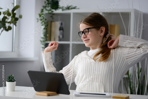 lazy girl stretching at the table, tired of learning, took a break, work from home