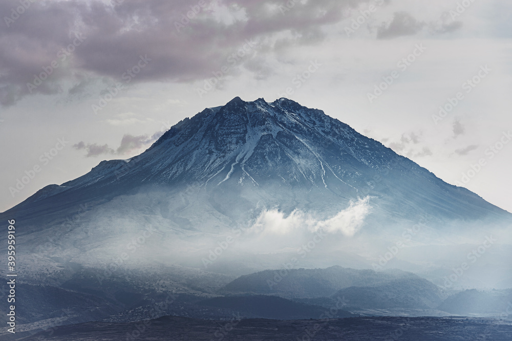 Fototapeta premium Snowy and foggy mountain peak