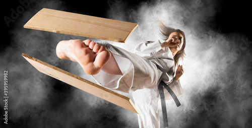 Woman in kimono practicing. Breaking board