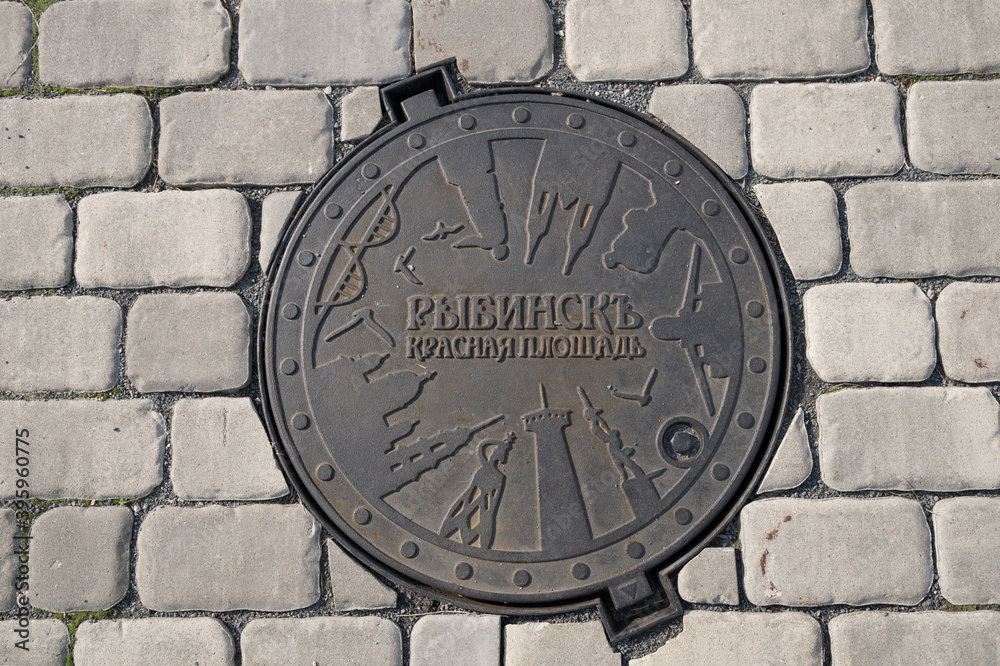 Cast iron manhole cover  on Red Square, Rybinsk, Yaroslavl region, Russia