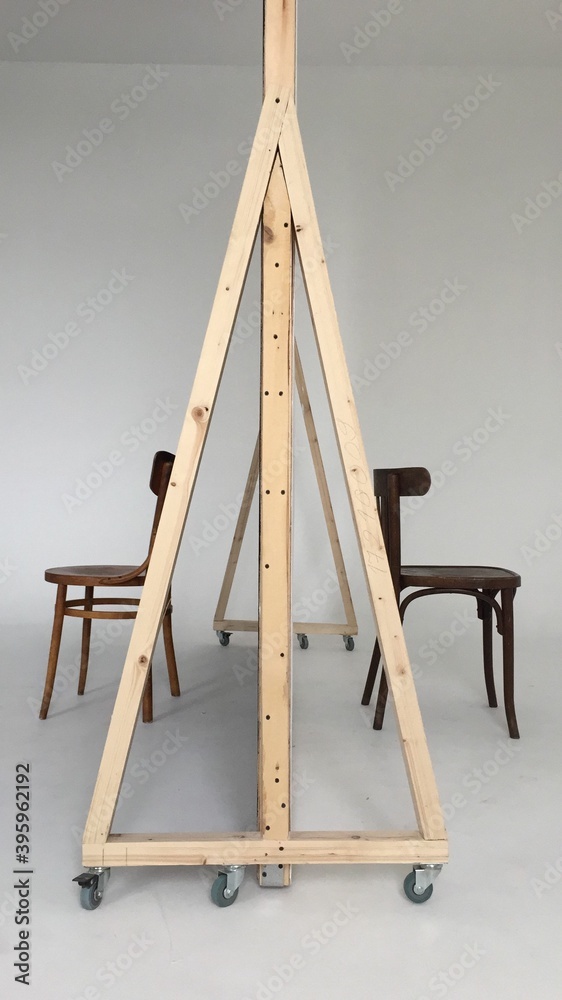 A corner of a photo studio with 2 chairs and a white cyclorama. checking the lights before shooting. Copy space. A corner of a photo studio with 2 chairs and a white cyclorama. checking the lights before shooting. Copy space.