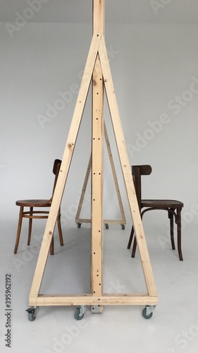 A corner of a photo studio with 2 chairs and a white cyclorama. checking the lights before shooting. Copy space.