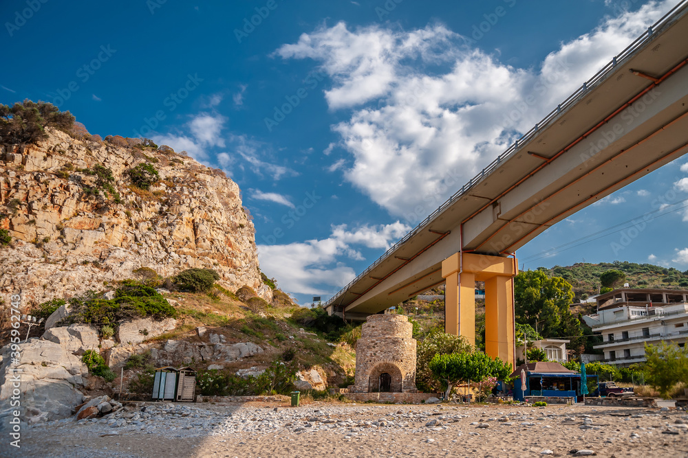Rocky beach under the pillars of the bridge Rocky beach under the pillars of the bridge