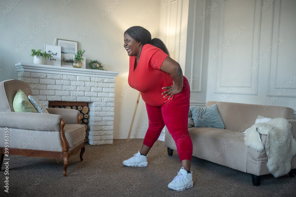 Plus size african american woman doing leaning to the sides Plus size african american woman doing leaning to the sides