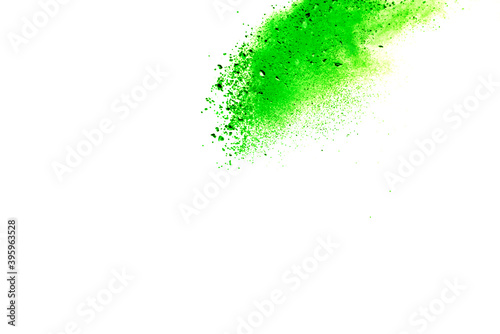 Freeze motion of green color powder exploding on white background.