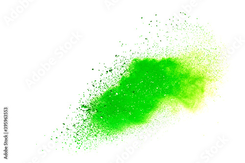 Freeze motion of green color powder exploding on white background.
