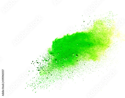 Freeze motion of green color powder exploding on white background.