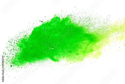 Freeze motion of green color powder exploding on white background.