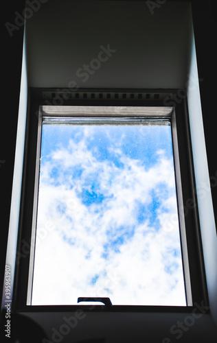 Image of attic window with blue sky view.