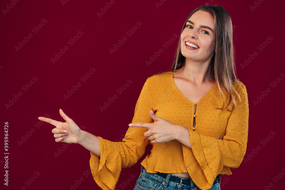 beautiful young girl pointing both hands with finger to the side beautiful young girl pointing both hands with finger to the side