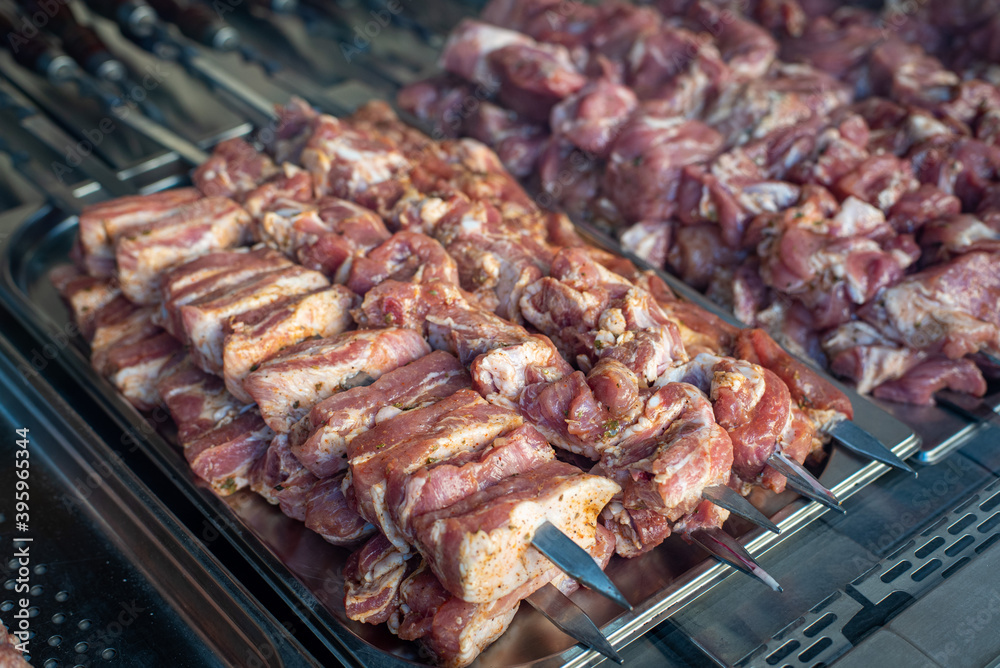 pork ribs prepared for grilling on skewers