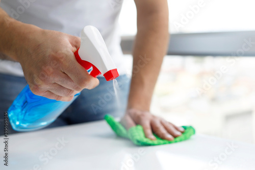 Man cleaning with a spray detergent