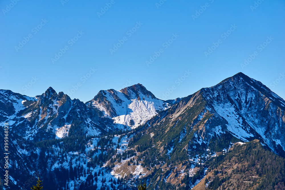 Fototapeta premium Three snowy mountains in autumn