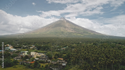 Tropic countryside with palm trees aerial. Mayon volcano hillside valley. Rural cityscape with cottages, lodges and fields. Cinematic Philippines tropical green farmland at nobody nature landscape