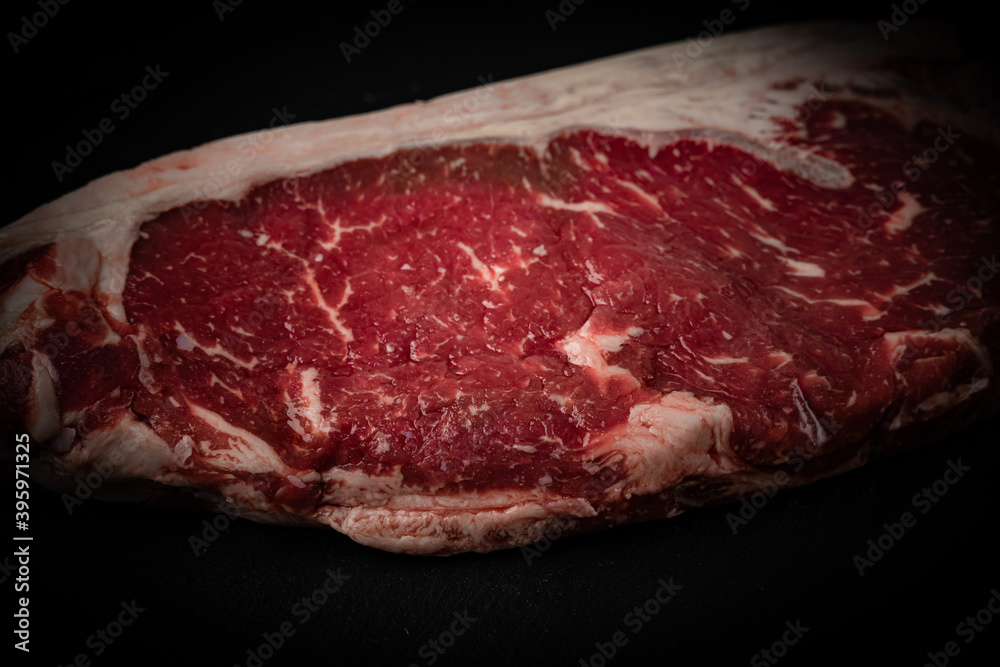 Raw ribeye beef steak. Texture of marble meat. Top view. 