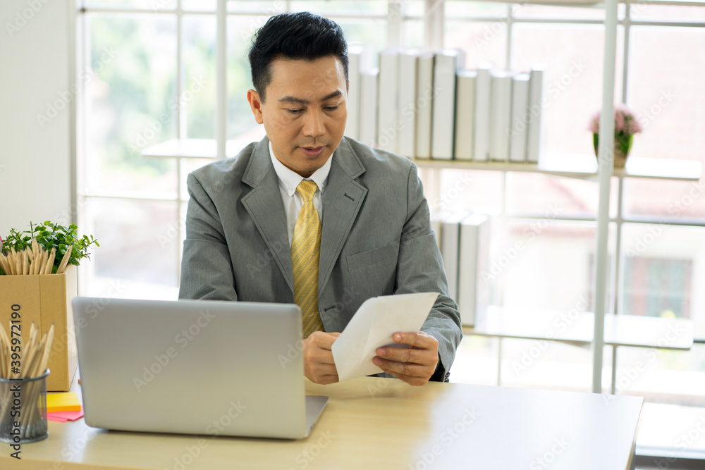 depressed worry Asian businessman wearing formal suit in the office feeling stressful from financial problem caused by virus pandemic. depressed worry Asian businessman wearing formal suit in the office feeling stressful from financial problem caused by virus pandemic.