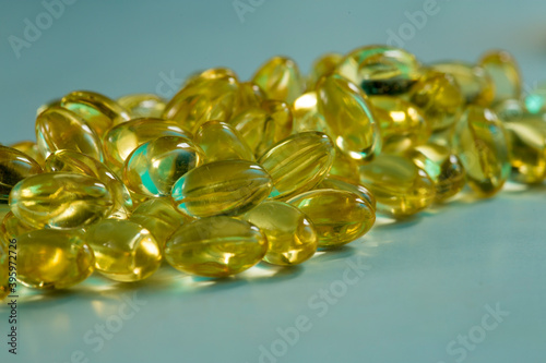Bunch of Vitamin D, fish oil capsule on blue