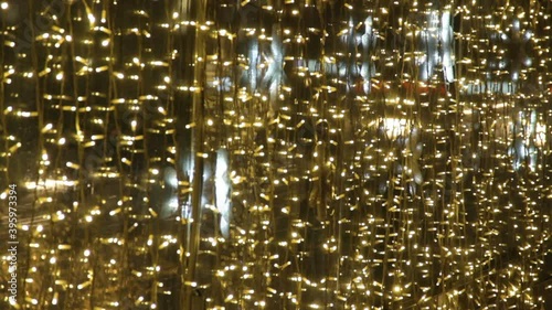 luminous bright snowflakes yellow coloured light bulbs of garland. Christmas street decorations, new year preparation in city. Decorated bridge