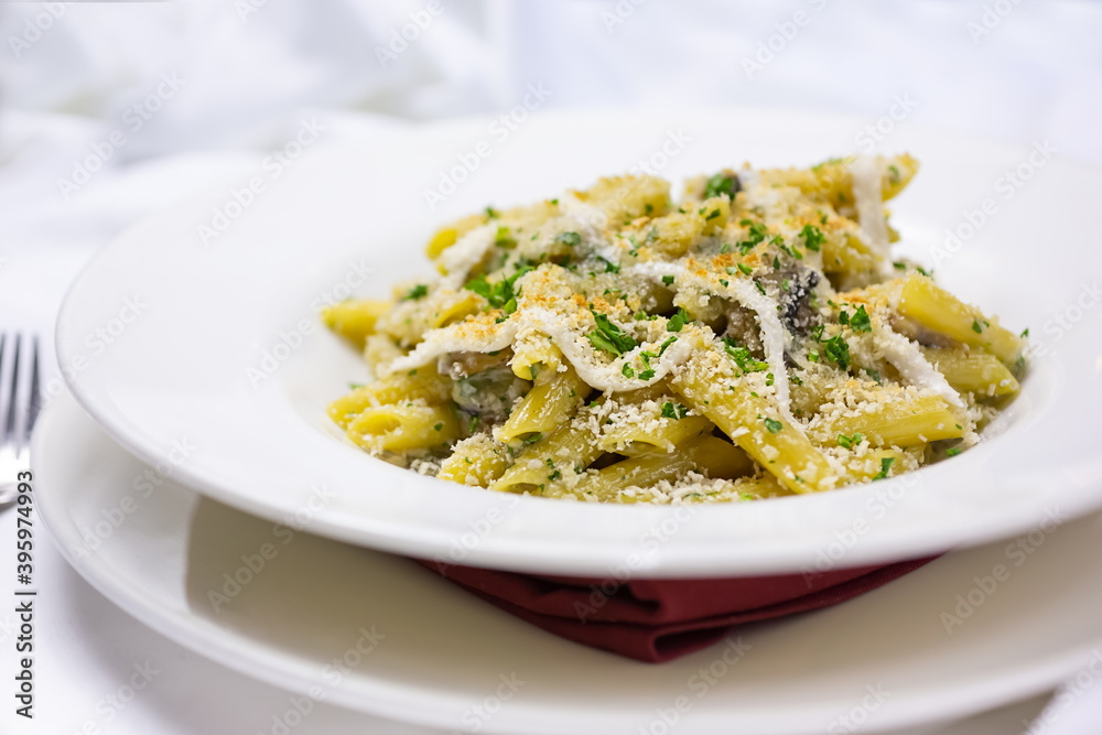 A view of a plate of rustic mac n cheese, in a restaurant or kitchen setting. A view of a plate of rustic mac n cheese, in a restaurant or kitchen setting.