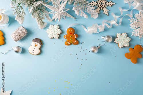 Christmas gingerbread cookies with silver Christmas decorations flat lay