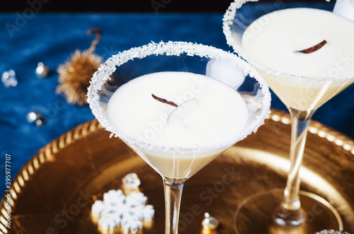 Winter cocktail with coconut flakes on gold tra . Christmas or New Year concept. photo