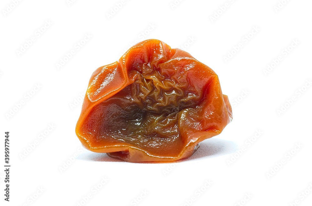 Rotten red cherry tomato on whote background with soft defocus. Studio shot of a vegetable Rotten red cherry tomato on whote background with soft defocus. Studio shot of a vegetable