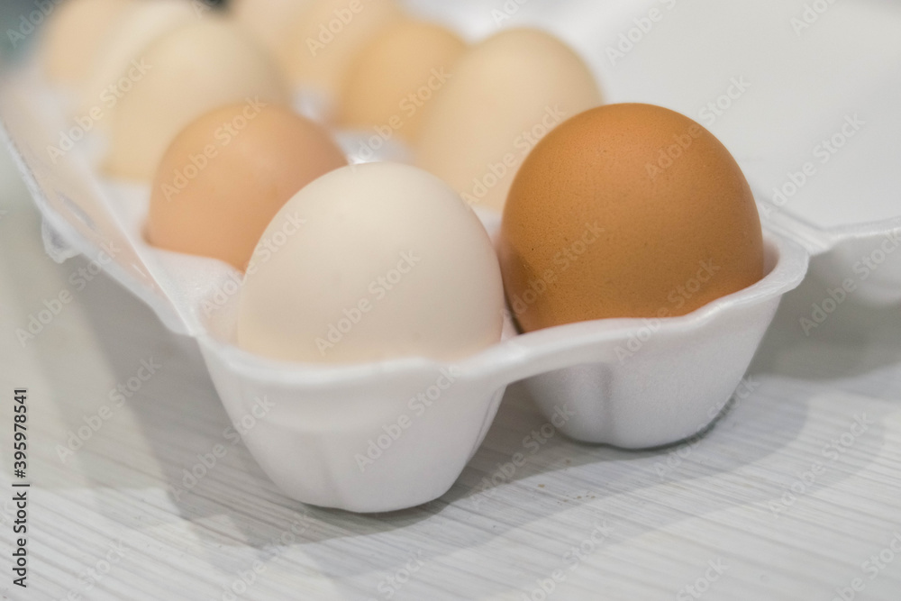 The eggs are in a row in a white tray The eggs are in a row in a white tray