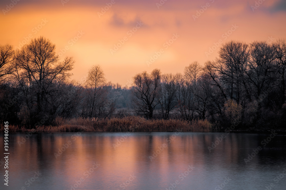 Island on the river in winter. Cold sunrise