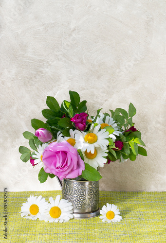 Rosehip rose and chamomile bouquet . Summer bouquet of garden flowers. Still life with daisies