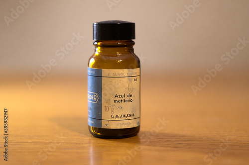Old chemical bottle with methylene blue. Its used as a tincture to stain certain parts of the body before or during surgery. Its use is mainly as a topical antiseptic and internal healing. photo