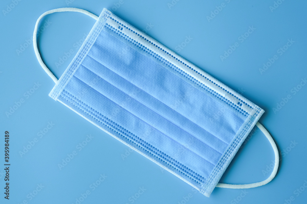 Medical mask on blue background, Coronavirus protection concept. Medical mask on blue background, Coronavirus protection concept.