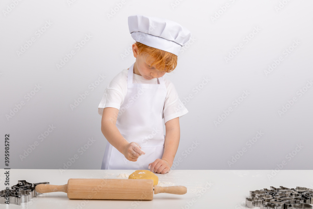 Junge mit roten Haaren hat Spaß beim Plätzchen backen. Junge mit roten Haaren hat Spaß beim Plätzchen backen.