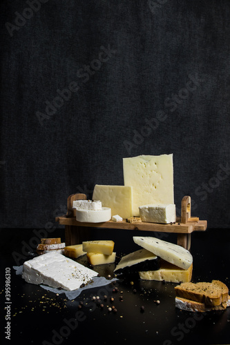 Traditional Greek cheeses on a dark background