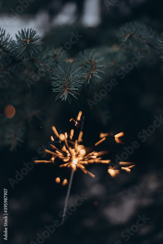 christmas tree and sparkler, bengal light on green background
