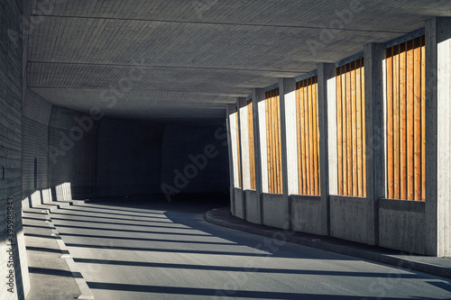 Avalanche gallery with wooden slats goes over into a dark concrete street tunnel