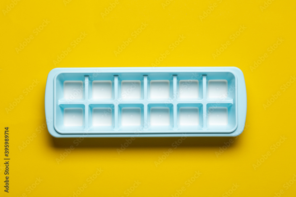 Blue plastic mold for making ice cubes for use in cocktails. Space for text.