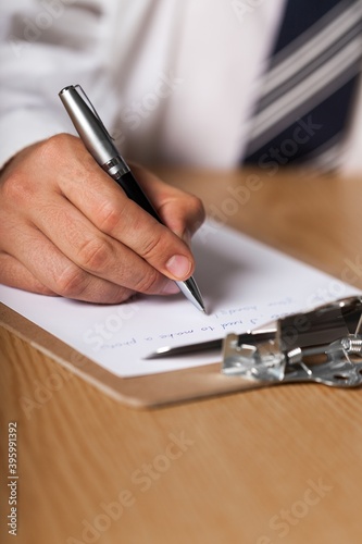 Businessman Taking Notes on a Clipboard
