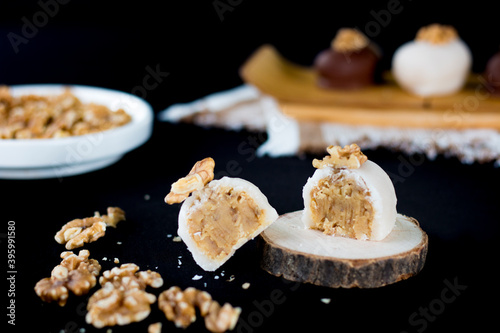 Cameo cut in half stuffed. White cameo stuffed. Cameo dessert. Cameos with nuts on top. Sweet cameo on the table.