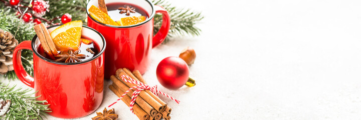 Mulled wine. Traditional christmas and winter drink with red wine, citrus and spices. Long banner format.